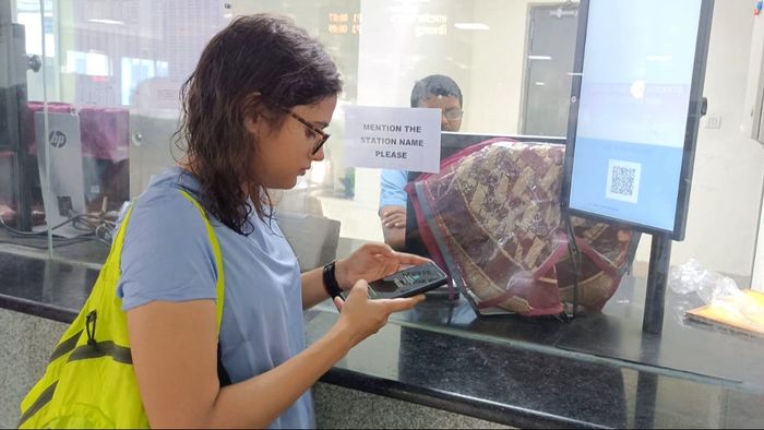 A commuter purchasing a QR code based ticket through UPI payment at Central Park Station