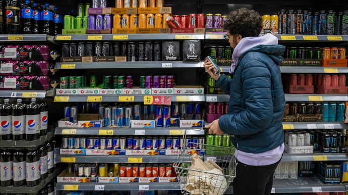 Man shopping in a supermarket while on a budget. He is looking for low prices due to inflation. He is living in the North East of England. Man shopping in a supermarket while on a budget. He is looking for low prices due to inflation. He is living in the North East of England.