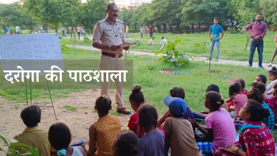 Police officer teaching slum kids Police officer teaching slum kids