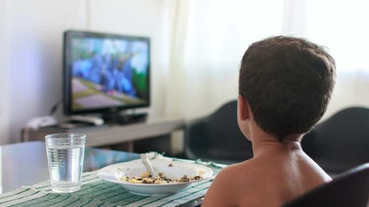 Child watching TV while eating Child watching TV while eating