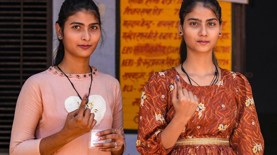 Women voters show their fingers marked with indelible ink Women voters show their fingers marked with indelible ink