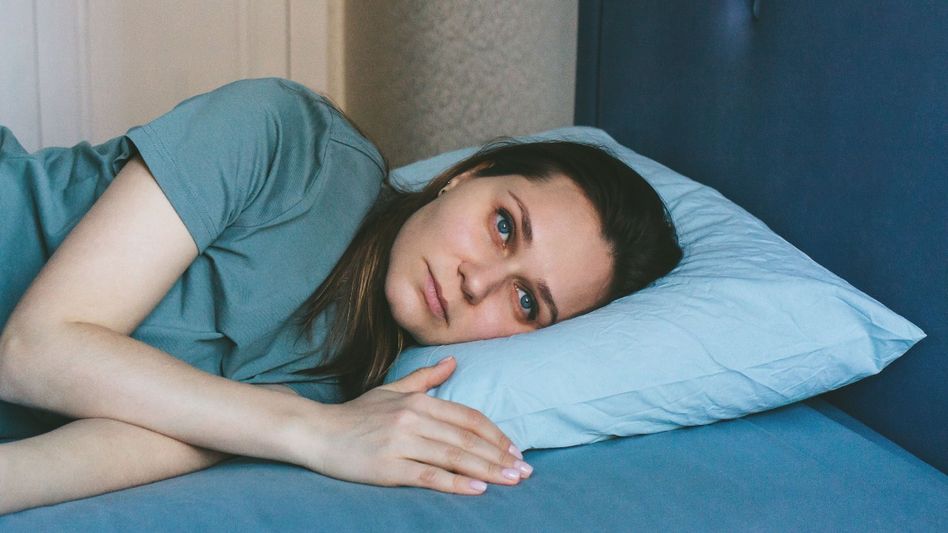 A beautiful woman is lying in bed. Asleep, trying to sleep. The concept of insomnia, sleep problems, loneliness, home comfort, wellness, harmony, inner freedom, feminism. A beautiful woman is lying in bed. Asleep, trying to sleep. The concept of insomnia, sleep problems, loneliness, home comfort, wellness, harmony, inner freedom, feminism.