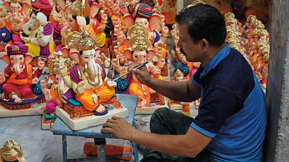 GOD IN THE DETAIL: An artisan gives final touches to a Ganesh idol at a workshop in Pen. GOD IN THE DETAIL: An artisan gives final touches to a Ganesh idol at a workshop in Pen.