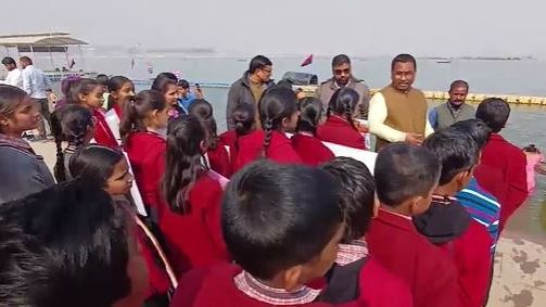 माघ मेले के बारे में ज्ञान लेते बच्चे