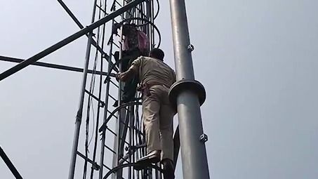 Woman climbs mobile tower 
