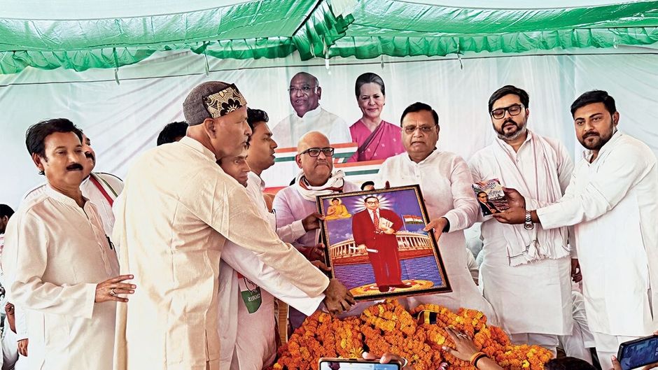 यूपी के बस्ती में संविधान बचाओ रैली के दौरान डॉ. आंबेडकर की तस्वीर देकर अपने नेताओं का स्वागत करते कांग्रेस कार्यकर्ता