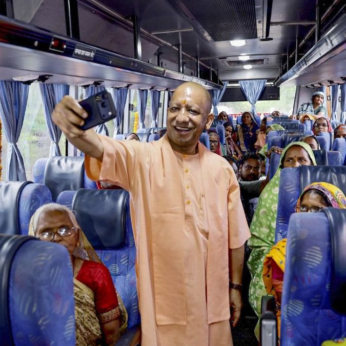 बस में महिलाओं के साथ सेल्फी लेते योगी आदित्यनाथ