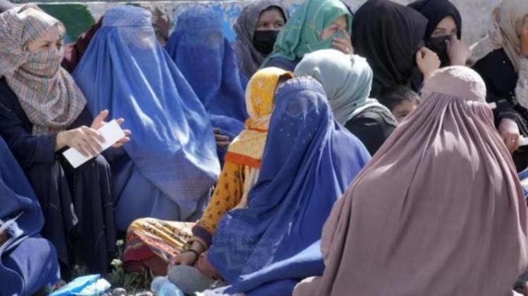 Afghan women wait to receive food rations distributed by a Saudi humanitarian aid group, in Kabul, Afghanistan. (File photo credits: AP) 