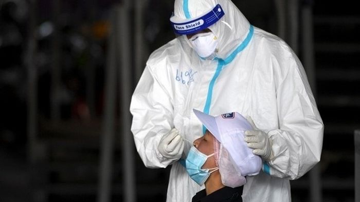 A healthcare worker takes a nasal swab sample from a migrant worker during proactive testing at his work place, amid the spread of the coronavirus disease (COVID-19) outbreak in Samut Sakhon province in Thailand, January 27, 2021. REUTERS/Chalinee Th