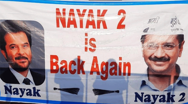 “Nayak 2 is Back Again,” Reads Banner at Arvind Kejriwal’s Swearing-in Ceremony Venue “Nayak 2 is Back Again,” Reads Banner at Arvind Kejriwal’s Swearing-in Ceremony Venue