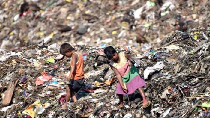 Rag pickers rummage though the sea of trash at the sea of trash at 'Deepor Beel'