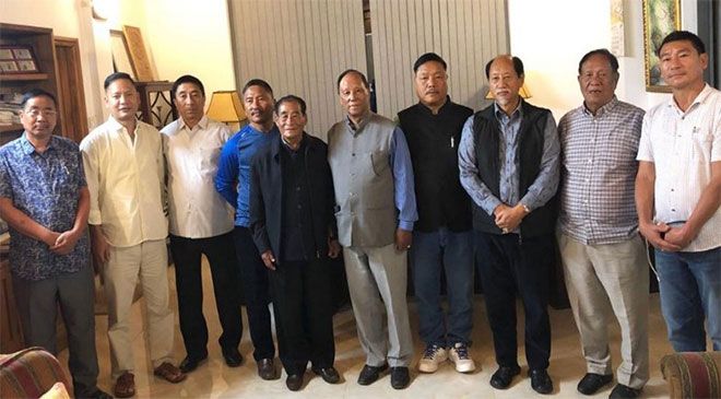 The seven opposition MLAs posing with Nagaland Chief Minister Neiphiu Rio