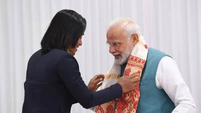 Hima Das presents the traditional Assamese Gamucha to PM Modi