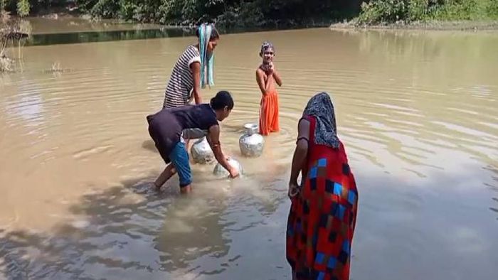 Assam: Dirty, muddied drinking water being drawn by locals of Ainkhal Tea Garden area, Hailakandi