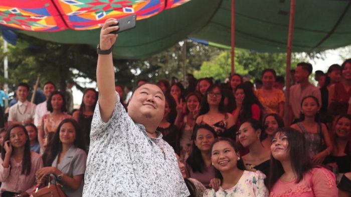 Nagaland's education minister while posing with students of Tetso College