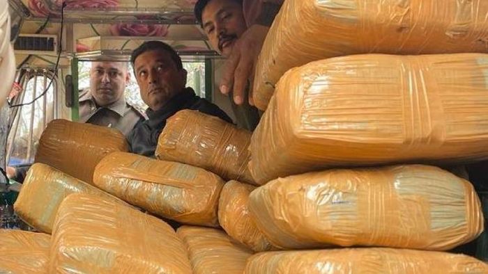 Assam: Guwahati Joint CP Partha Sarathi Mahanta (C) with the seized consignment of Marijuana