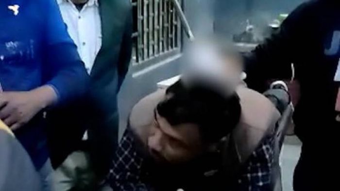 the victim teacher with the rod at his back