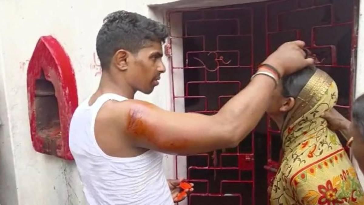Lover applying sindoor on woman's forehead