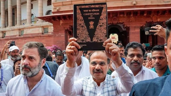 Congress MP Adhir Ranjan Chowdhury holding a copy of Constitution of India