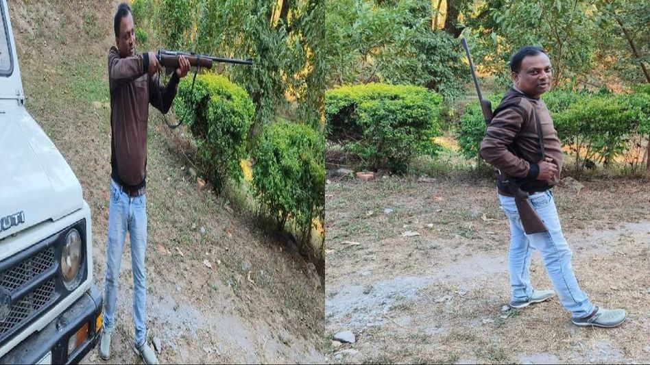 Assam: Tourist poses for pics with forest official's gun at Manas National Park, lands in trouble Assam: Tourist poses for pics with forest official's gun at Manas National Park, lands in trouble