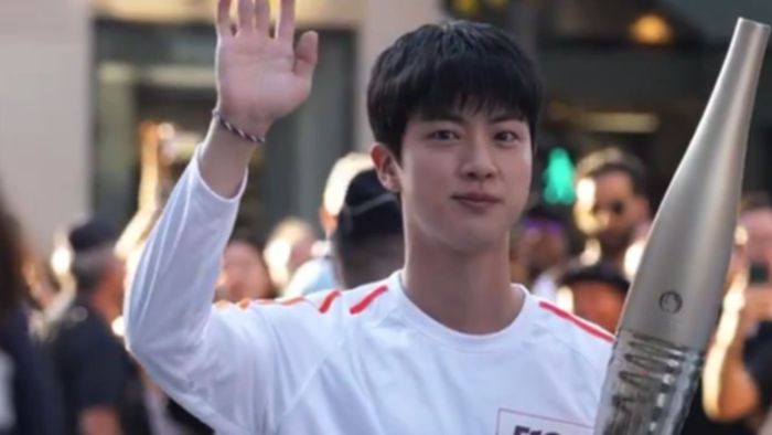 BTS star Jin lights up Paris Olympics torch relay