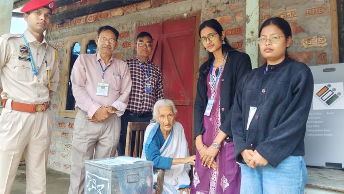 : Polling officials in Kamrup assist an elderly woman cast her vote through postal ballot