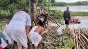 Assam floods: 106-year-old woman cremated on tiny patch of dry land in submerged Jorhat village Assam floods: 106-year-old woman cremated on tiny patch of dry land in submerged Jorhat village