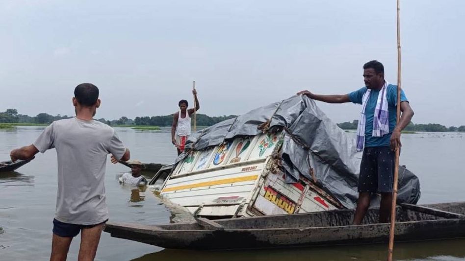 Relief truck carrying flood aid meets with accident in Assam's Sivasagar, locals use boats to salvage supplies Relief truck carrying flood aid meets with accident in Assam's Sivasagar, locals use boats to salvage supplies