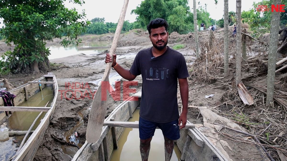 Shravan Prasad aboard the boat he used to ferry stranded residents to safety after floodwaters inundated Nepali Khuti village in Sivasagar