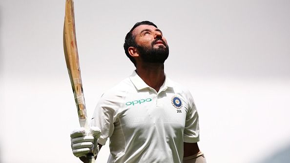 Century maker Cheteshwar Pujara of India looks to the sky