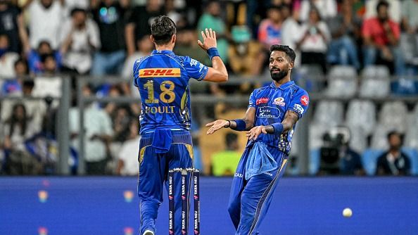 Mumbai Indians' Trent Boult (L) celebrates with captain Hardik Pandya =