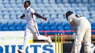 WI vs AUS : पिंक बॉल टेस्ट मैच के पहले दिन शमार जोसेफ के कहर से कांपी ऑस्ट्रेलिया, पहली पारी में बना सकी 225 रन West Indies' Shamar Joseph (L) celebrates after dismissing Australia's Travis Head on Day 1 of 3rd Test