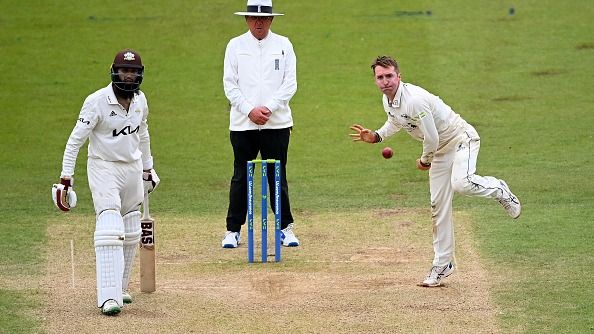 Tom Smith bowls watched on by Hashim Amla
