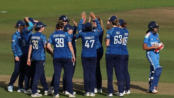 Sophie Ecclestone of England celebrates with team mates after dismissing Pratika Rawal