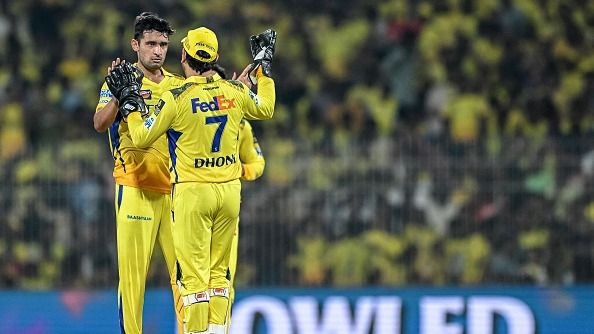 Chennai Super Kings' Anshul Kamboj (L) celebrates with captain MS Dhoni