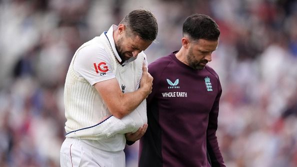 England's Chris Woakes heads off with an injury