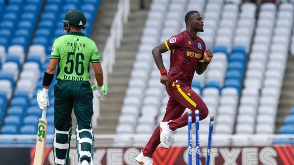 Jayden Seales (R) of West Indies celebrates the dismissal of Babar Azam (L) of Pakistan