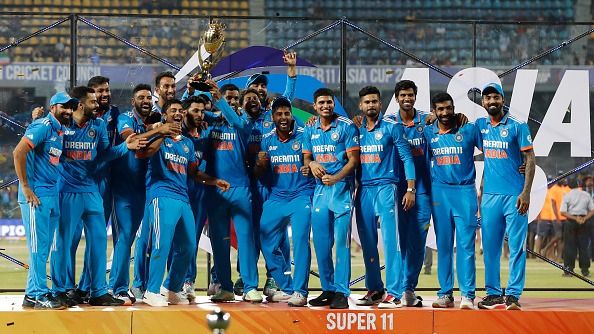 India's players celebrate with the trophy after winning the during the Asia Cup Final