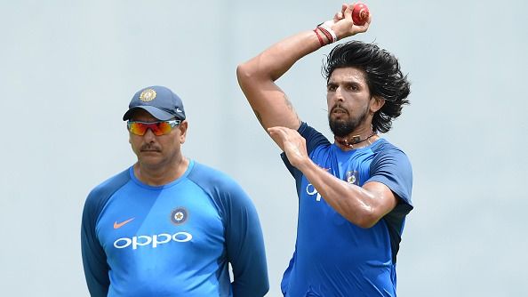 India's cricketer Ishant Sharma (R) delivers a ball as coach Ravi Shastri look on