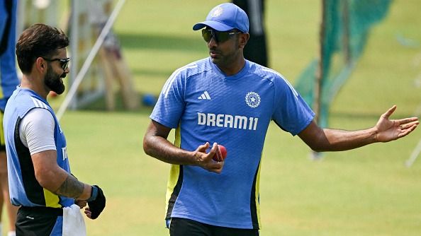 India's Ravichandran Ashwin (R) and Virat Kohli attend a practice session