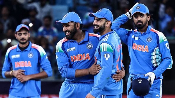India's captain Rohit Sharma (2L) and his teammate Virat Kohli (2R) celebrate their team's win