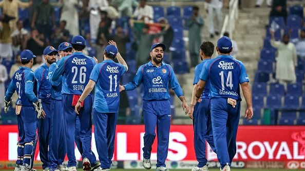 Afghanistan's captain Rashid Khan (3R)
