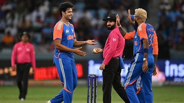 India's Shivam Dube (L) celebrates with teammates after taking the wicket of UAE's Dhruv Parashar