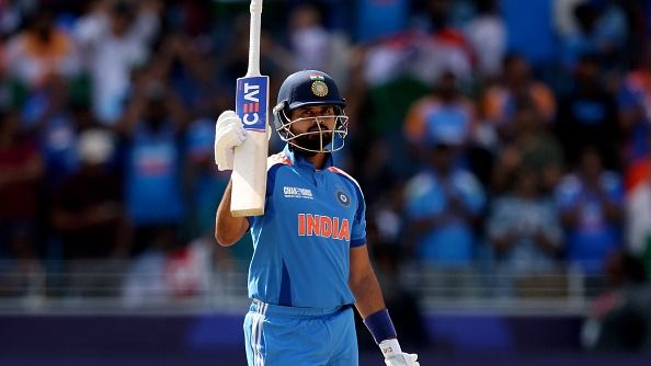 Shreyas Iyer of India raises his bat as he acknowledges the fans