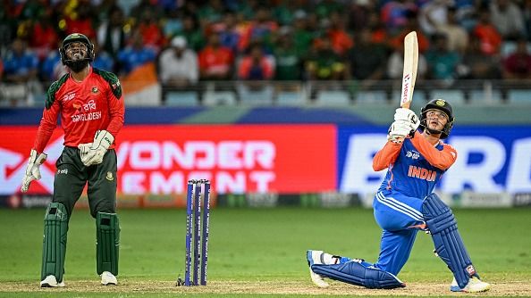 India's Abhishek Sharma (R) watches the ball after playing a shot during the Asia Cup