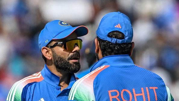 India's Virat Kohli (L) speaks with his captain Rohit Sharma