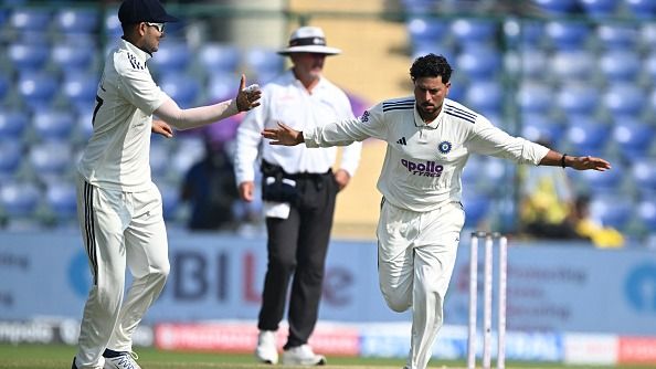 Kuldeep Yadav (R) celebrates after taking the wicket of West Indies' Shai Hope