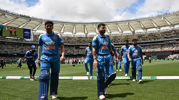 India's captain Shubman Gill (L) walks with his team off the field