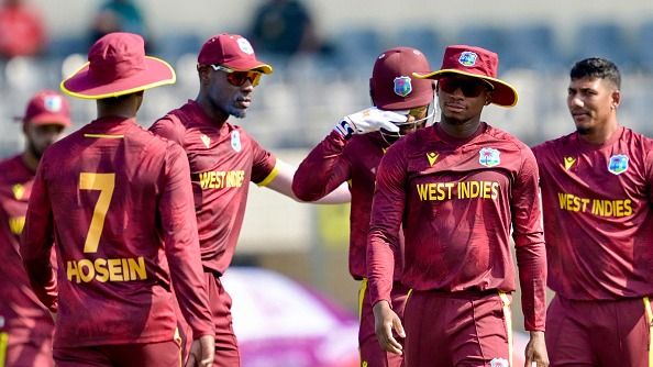West Indies' Gudakesh Motie (R) celebrates with teammates