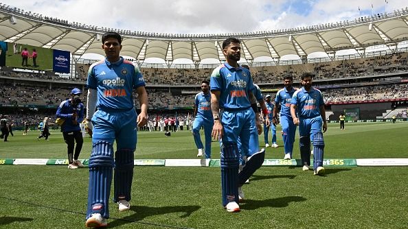 India's captain Shubman Gill (L) walks with his team off the field